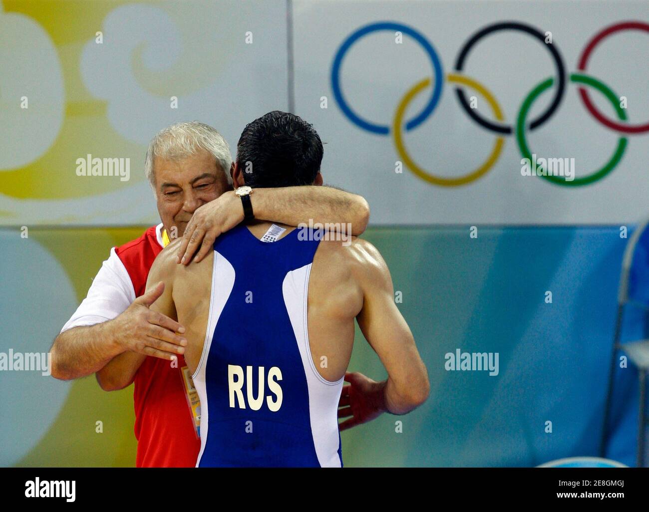 Buvaysa Saytiev of Russia is hugged by his coach after defeating Soslan Tigiev of Uzbekistan in their 74kg men's freestyle wrestling final match at the Beijing 2008 Olympic Games August 20, 2008.     REUTERS/Oleg Popov (CHINA) Stock Photo