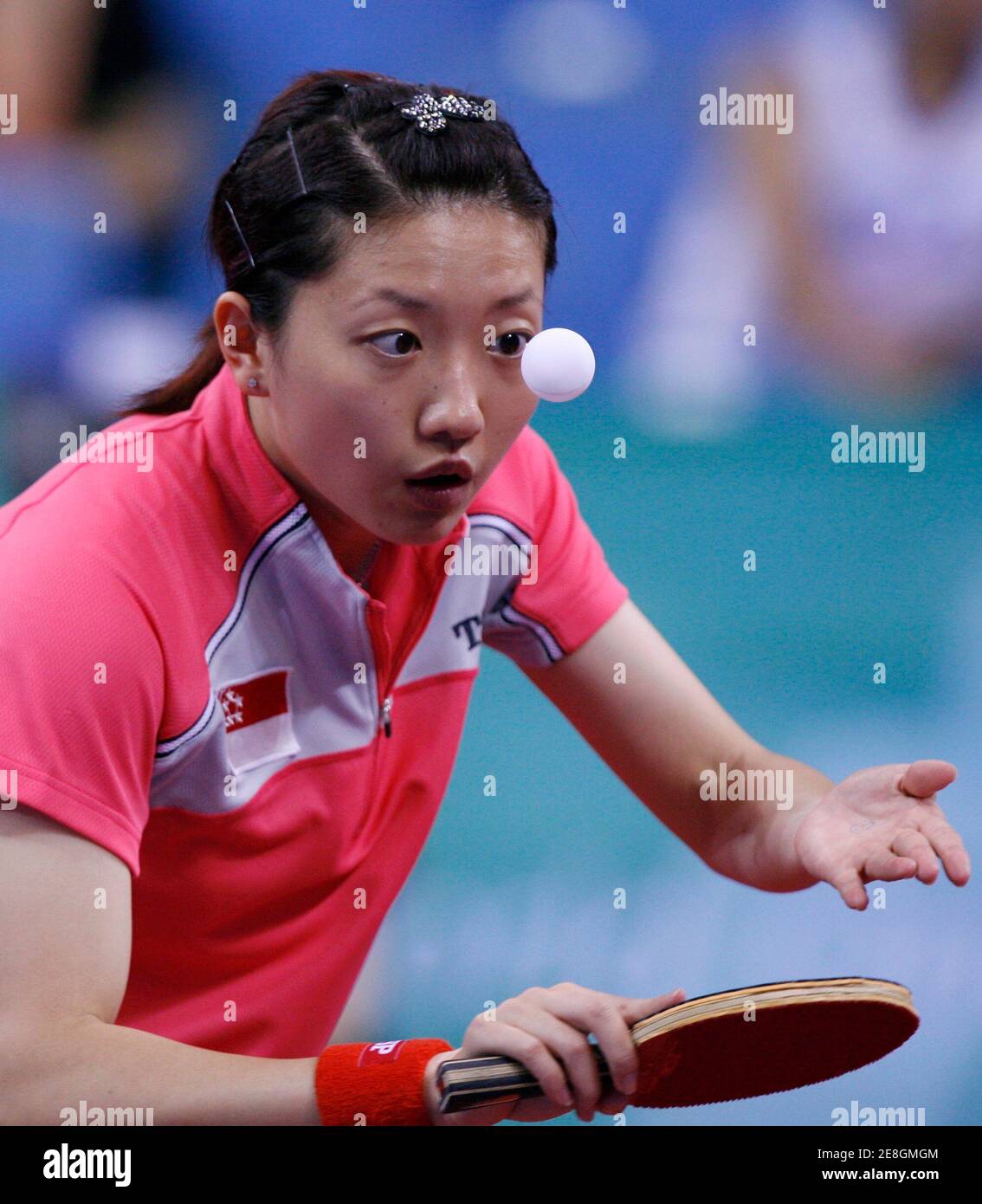 Li Jia Wei of Singapore serves to Tamara Boros of Croatia during their women's singles third round table tennis match at the Beijing 2008 Olympic Games August 20, 2008     REUTERS/Beawiharta (CHINA) Stock Photo