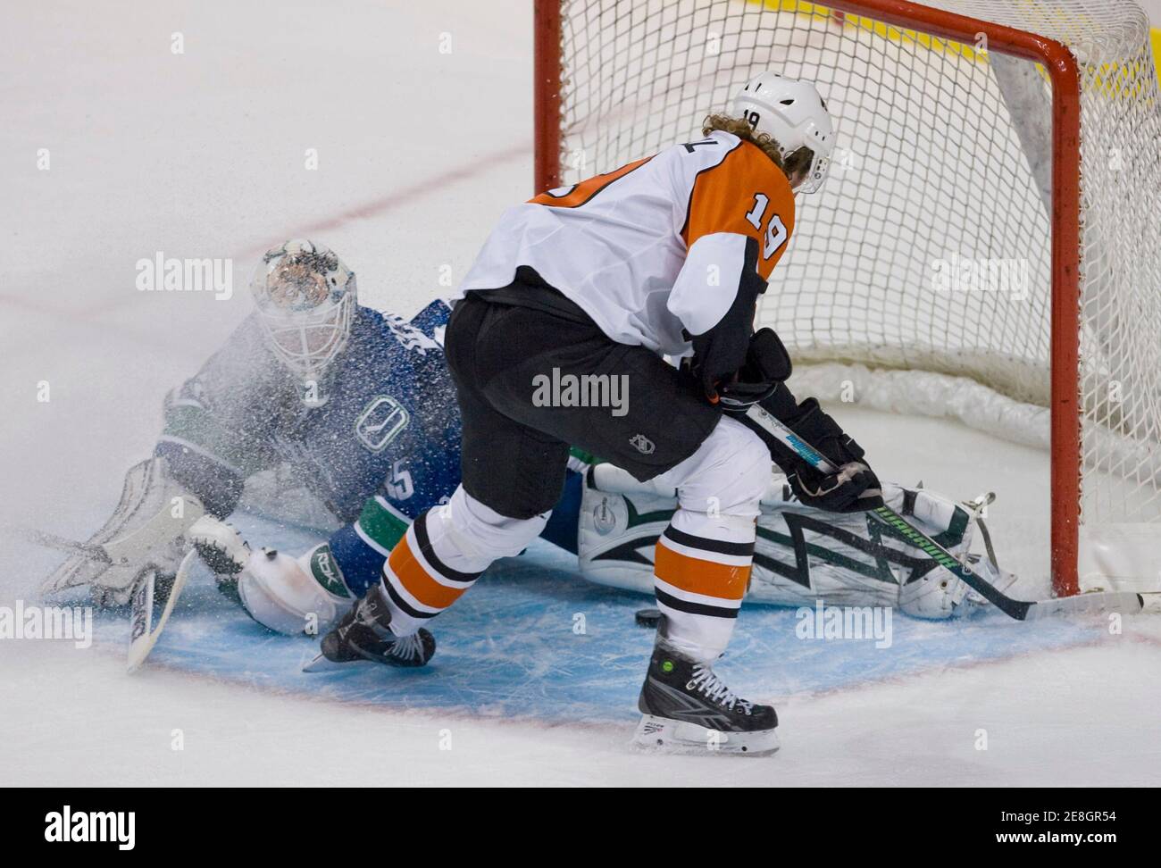 Vancouver Canucks goalie Cory Schneider (L) stops Phildadelphia Flyers Scott Hartnell during third period NHL hockey in Vancouver, British Columbia December 30, 2008.         REUTERS/Andy Clark     (CANADA) Stock Photo