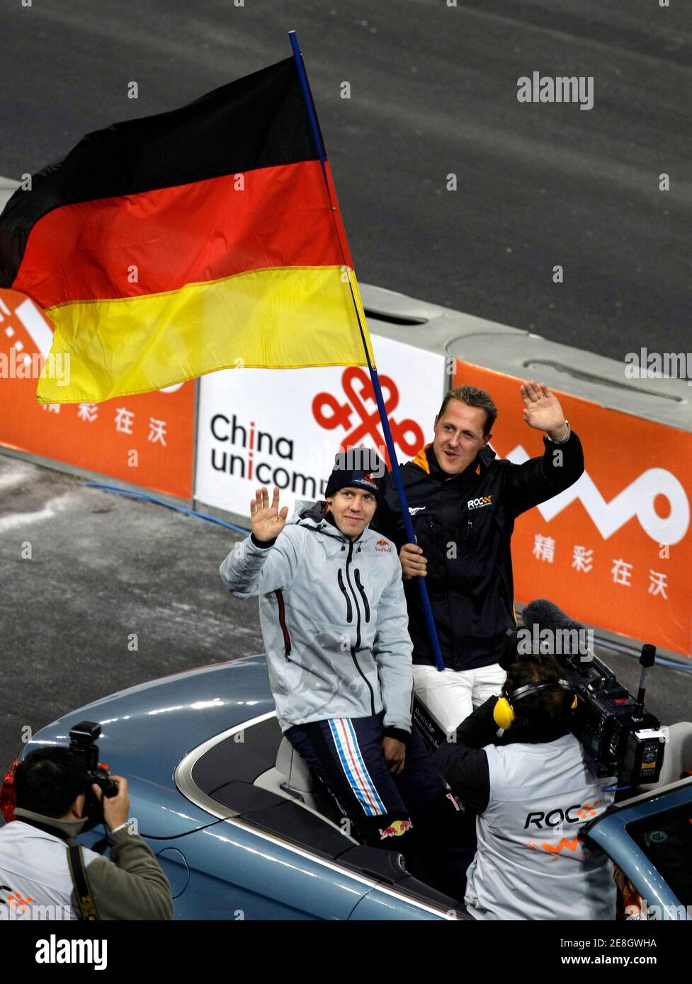 Team Germany's Michael Schumacher (R) and Formula One Red Bull driver Sebastian Vettel arrive for the Race of Champions (ROC) Nations Cup at the 'Bird's Nest' National Stadium in Beijing November 3, 2009. REUTERS/Jason Lee(CHINA SPORT MOTOR RACING) Stock Photo