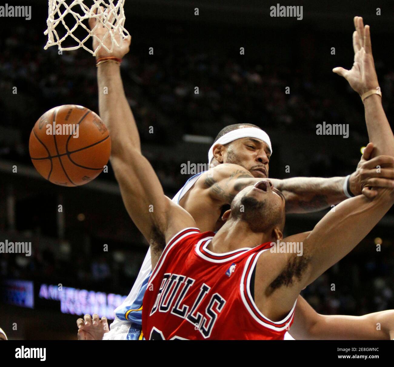 Chicago Bulls forward Taj Gibson is defended by Denver Nuggets forward Kenyon Martin in the third quarter of their NBA basketball game in Denver November 21, 2009. REUTERS/Rick Wilking (UNITED STATES SPORT BASKETBALL) Stock Photo