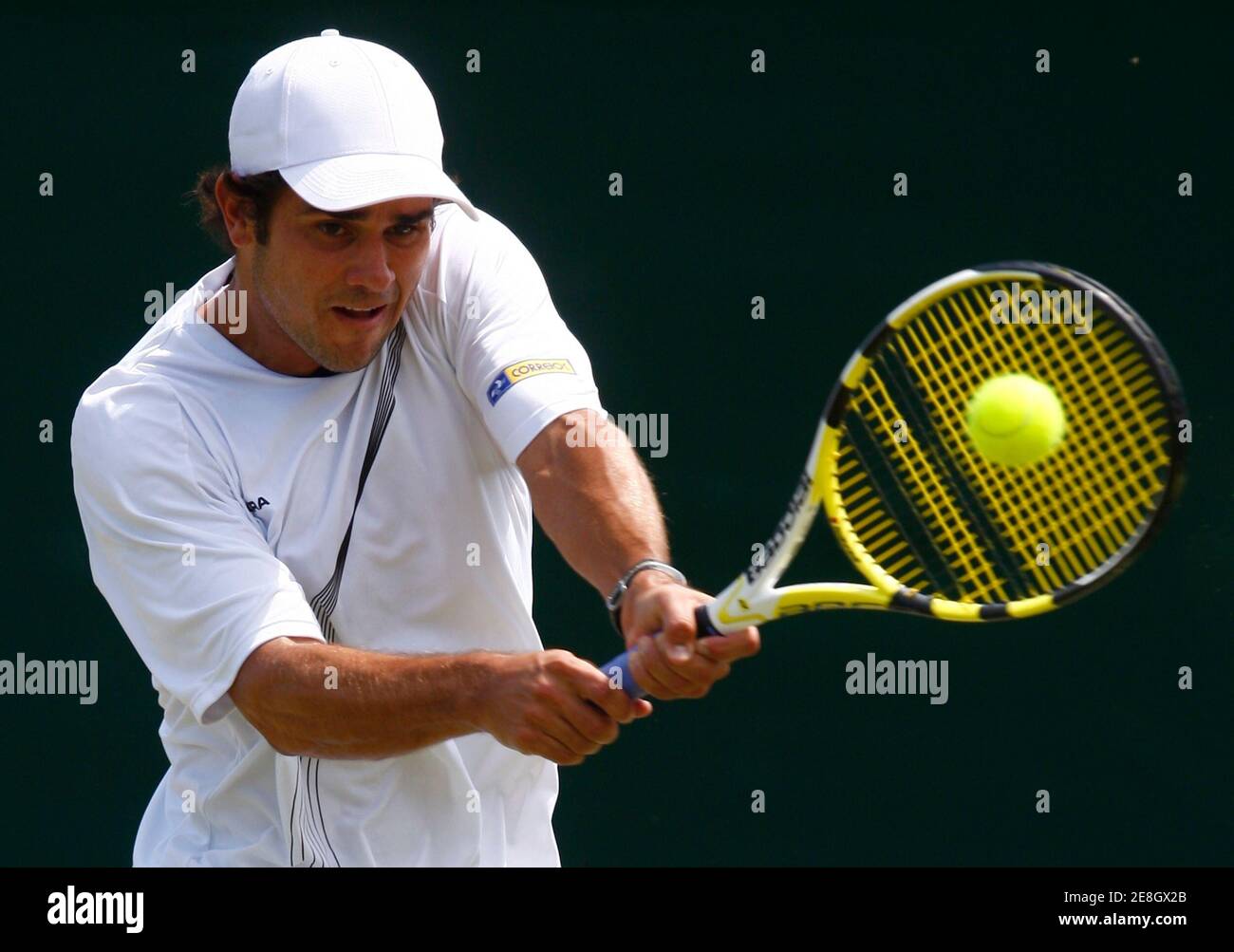 Thiago Alves of Brazil returns the ball to Gilles Simon of France during  their match at the Wimbledon tennis championships, in London June 25, 2009.  REUTERS/Eddie Keogh (BRITAIN SPORT TENNIS Stock Photo -