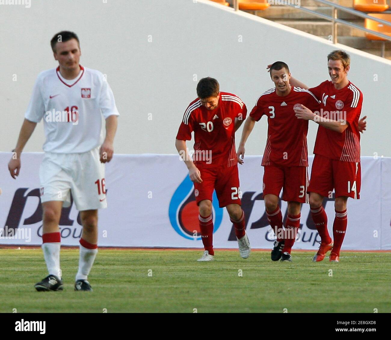 Denmark's Jesper Bech (2nd R) celebrates with teammates Soren Risks (R) and Martin Ornskov after he scored during their Thailand King's Cup football tournament against Poland at His Majesty The 80th Birthday Anniversary stadium in Nakhon Ratchasima province northeast of Bangkok, January 17, 2010. REUTERS/Chaiwat Subprasom  (THAILAND - Tags: SPORT SOCCER) Stock Photo