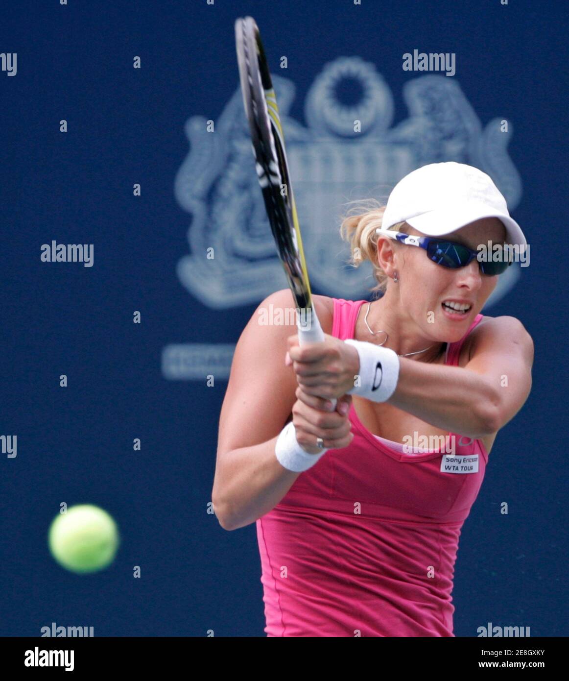 Anastasia Rodionova of Australia returns a shot to Olga Govortsova of  Belarus during the WTA Malaysian