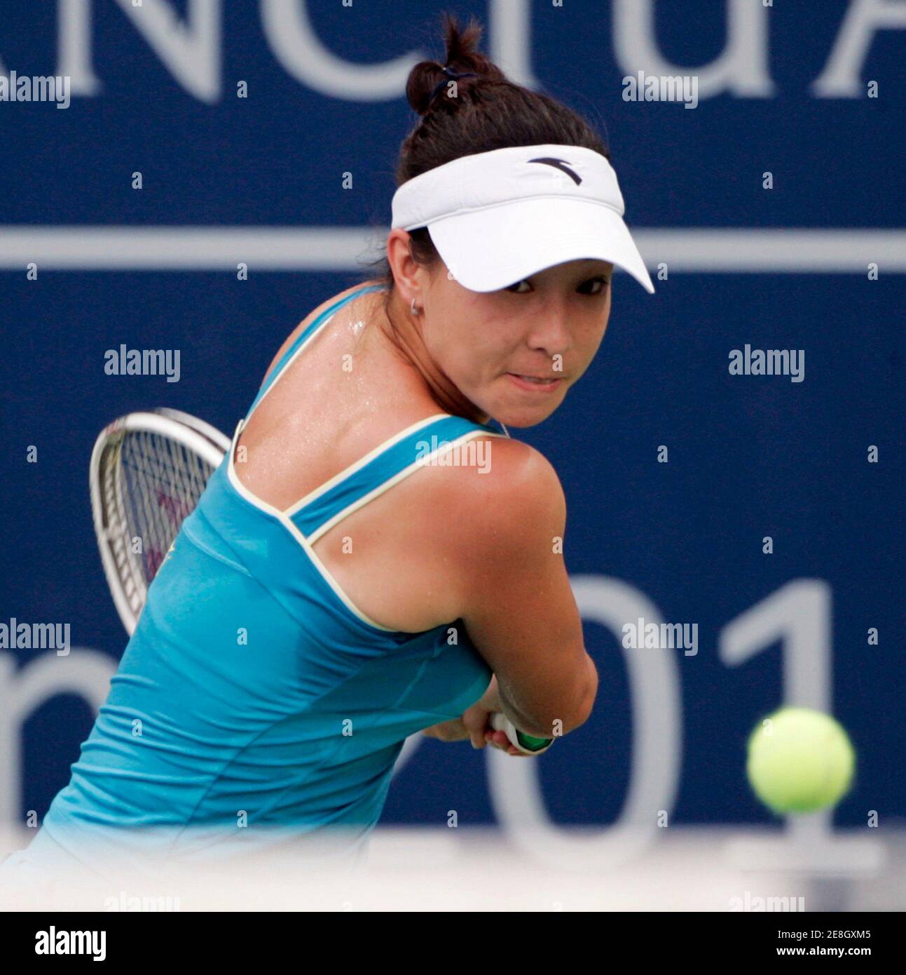 Zheng Jie of China returns a shot to Chang Kai-chen of Taiwan ...