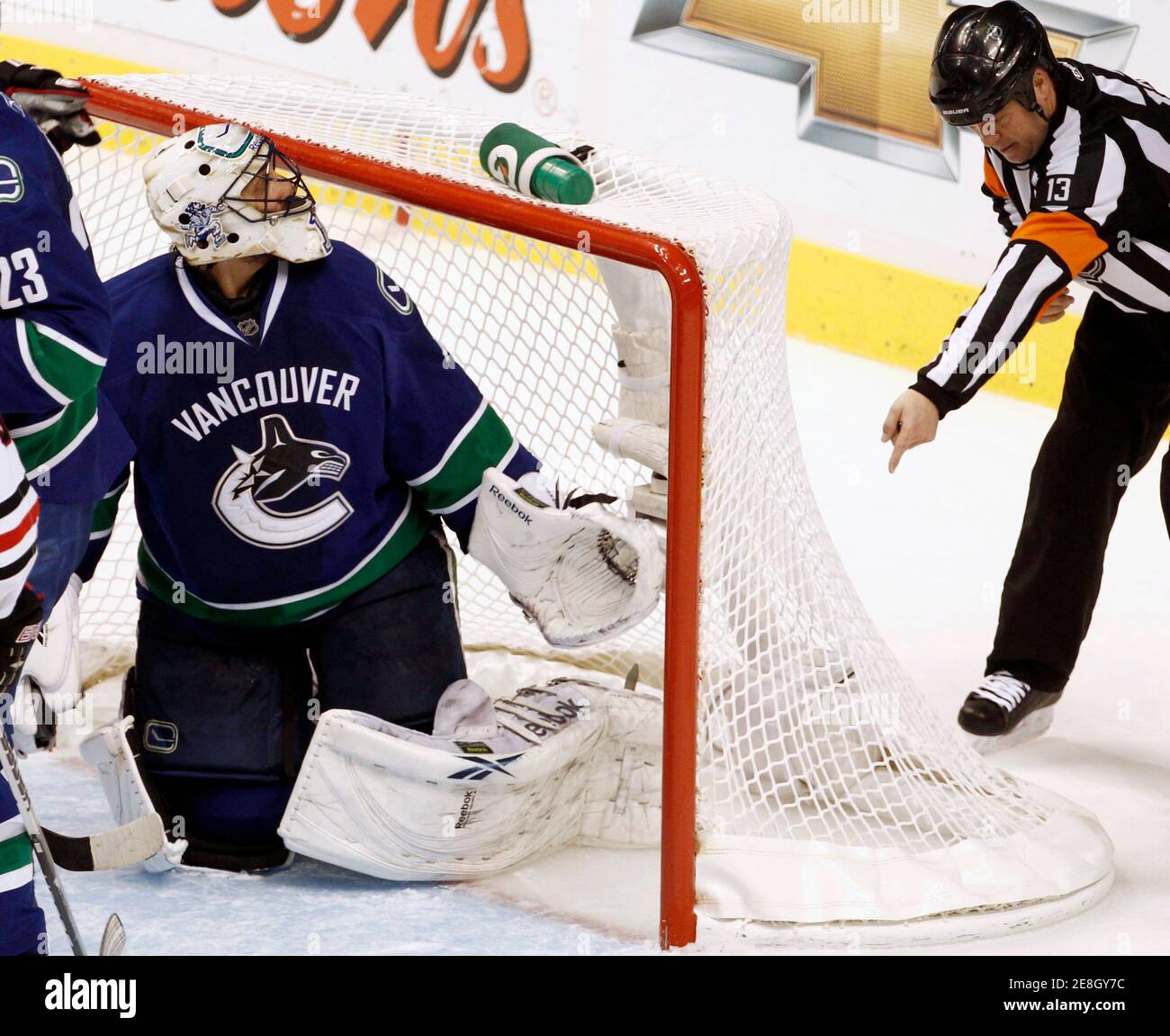 Vancouver Canucks goalie Roberto Luongo looks back at referee Dan O'Halloran who signals a Chicago Blackhawks goal in the third period during Game 3 of their NHL Western Conference semi-final hockey game in Vancouver, British Columbia May 5, 2010. REUTERS/Andy Clark (CANADA - Tags: SPORT ICE HOCKEY) Stock Photo