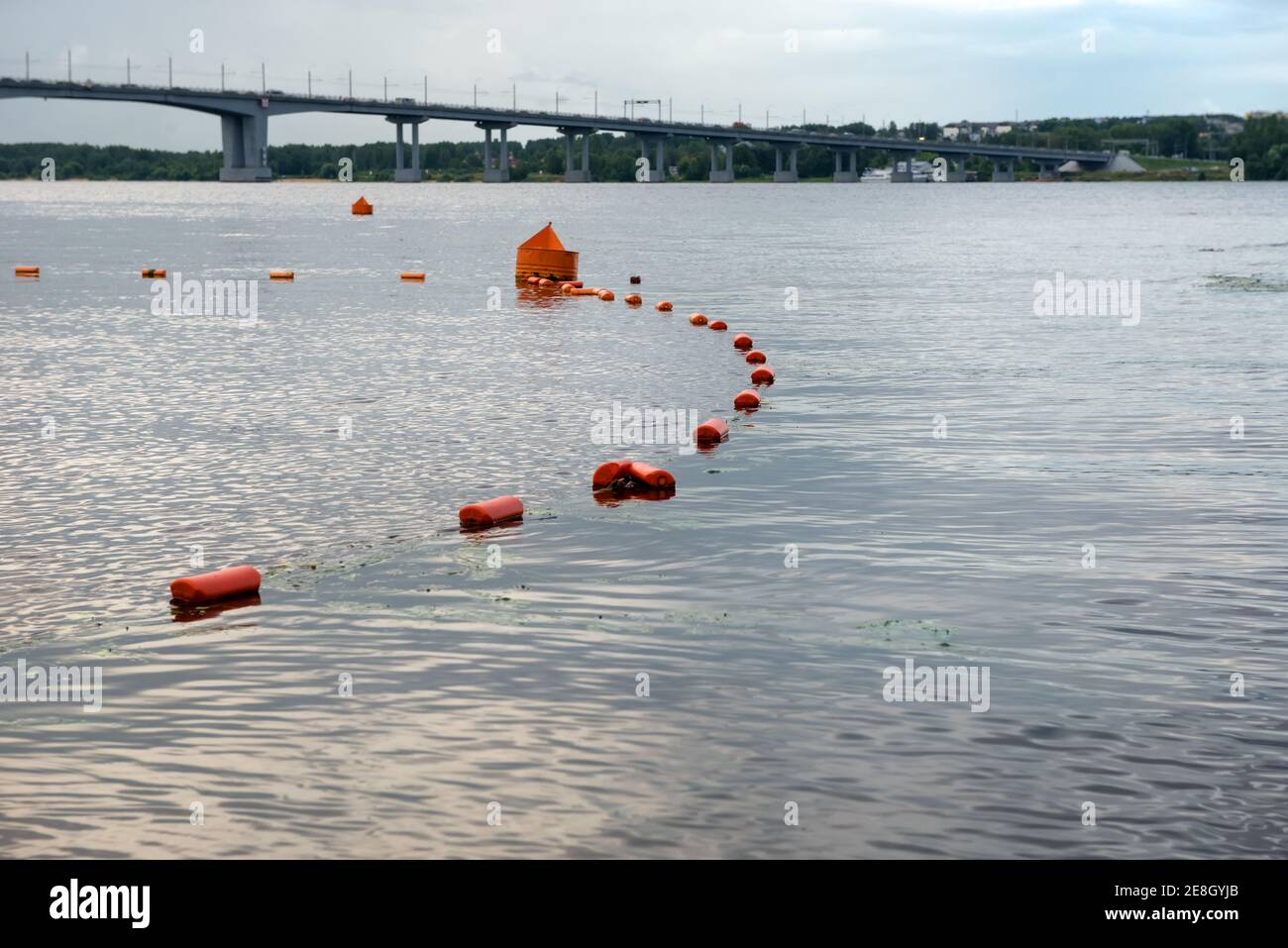 Buoys line the safe swimming area on the river on a summer evening