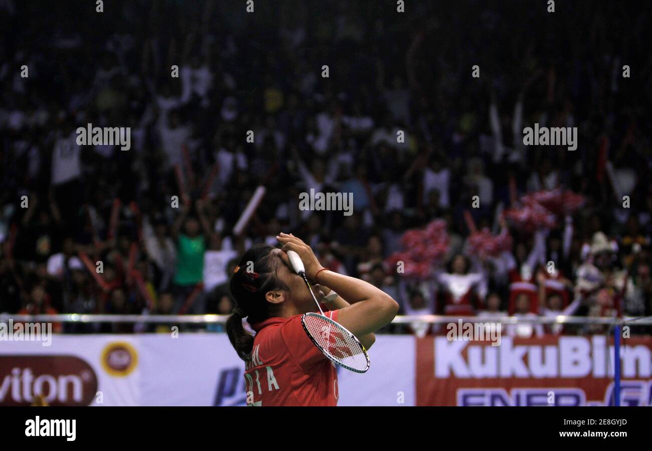 Saina Nehwal of India reacts after defeating Sayako Sato of Japan during their women's singles final match at the Djarum Indonesia Open Super Series badminton tournament in Jakarta June 27, 2010. REUTERS/Beawiharta (INDONESIA - Tags: SPORT BADMINTON) Stock Photo