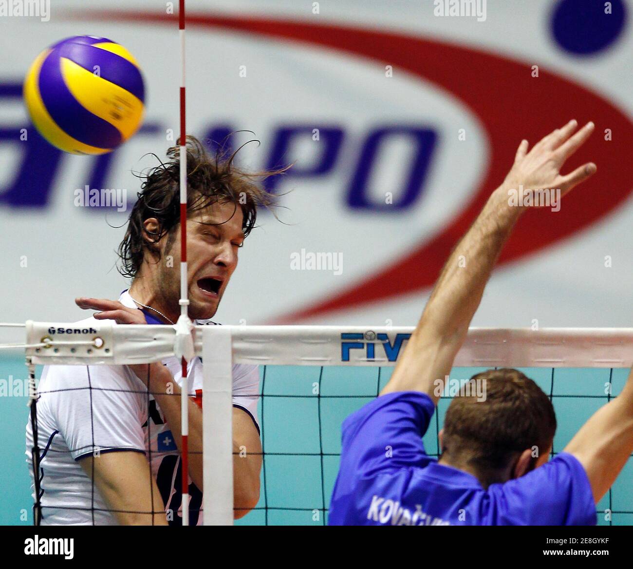 Italy's Matej Cernic (L) spikes the ball against Serbia's Nikola Kovacevic during their FIVB World League Pool-B intercontinental round volleyball match in Belgrade July 7, 2010. REUTERS/Ivan Milutinovic  (SERBIA - Tags: SPORT VOLLEYBALL) Stock Photo