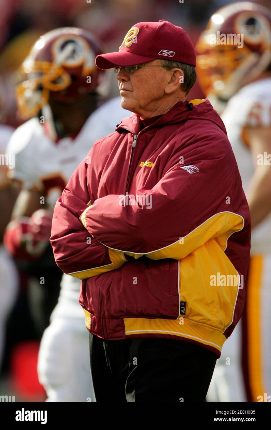 Washington Redskins head coach Joe Gibbs watches his team warm up prior to playing the New York Giants in Landover, Maryland, December 24, 2005. Gibbs' Redskins' defeated the Giants 35-20 to stay alive in their quest for post-season play, with one regular season game remaining in the NFL season. Picture taken December 24, 2005. REUTERS/Gary Cameron Stock Photo
