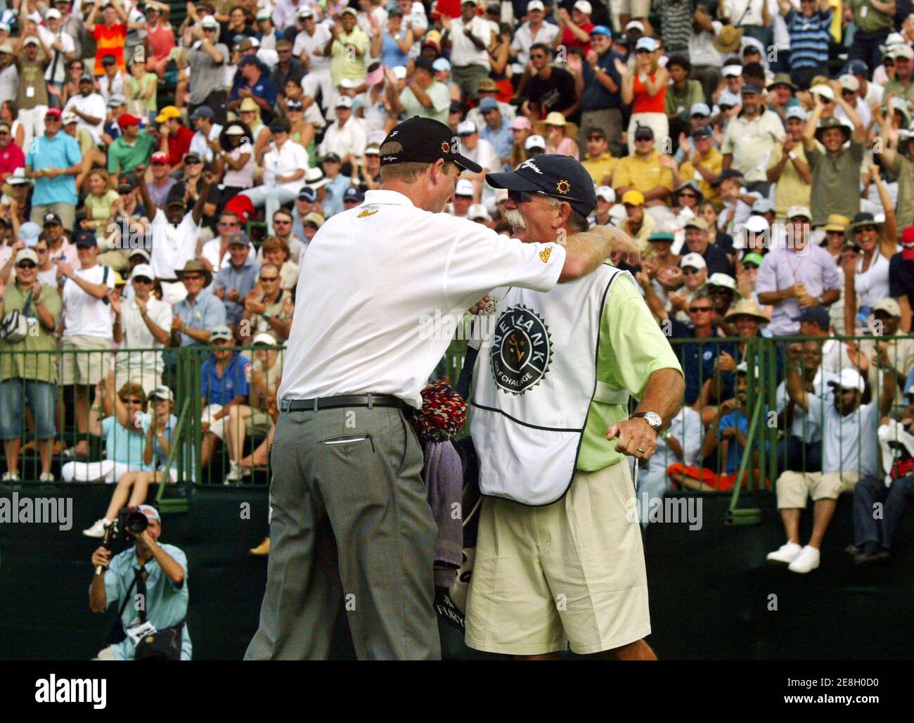 Jim Furyk (L) of the U.S. and his caddie Mike Cowan celebrate after Furyk won the Sun City Golf Challenge in Sun City, South Africa December 4, 2005. Furyk chipped in on the second extra hole of a sudden-death playoff to win the 25th Sun City Golf Challenge on Sunday. Furyk's birdie from 15-feet from the back of the par-four 18th green beat off Briton Darren Clarke and Australia's Adam Scott for the $1.2 million first prize. REUTERS/Juda Ngwenya Stock Photo