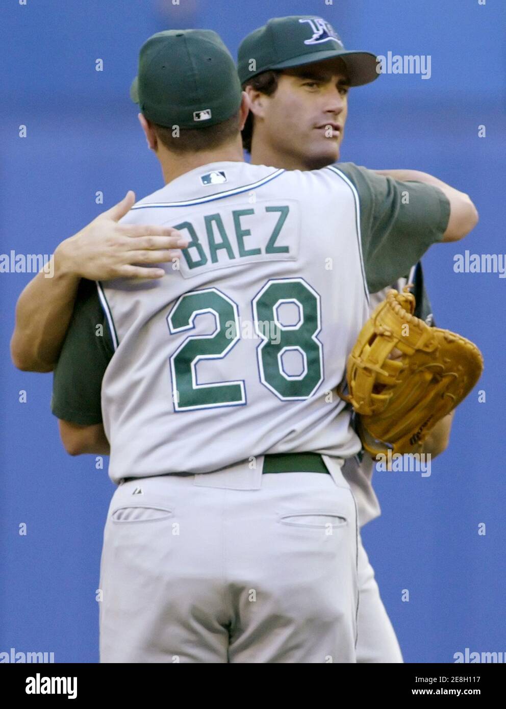 Tampa Bay Devil Rays' Travis Lee is congratulated by teammate Danys Baez  (28) at the end of American League play in Toronto, September 3, 2005. Lee  hit a game winning two run