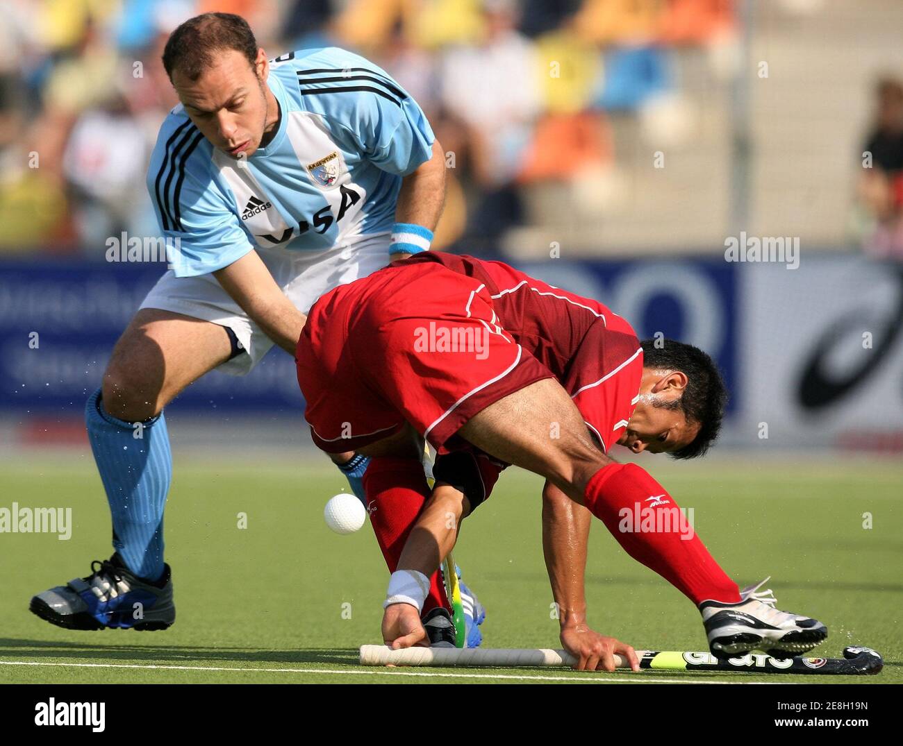 Japan's Yuji Chaki (R) fights for the ball with Argentina's Fernando Oscaris during their Men's Field Hockey World Cup match at the Warsteiner Hockey Park stadium in Moenchengladbach September 12, 2006. REUTERS/Pascal Lauener  (GERMANY) Stock Photo