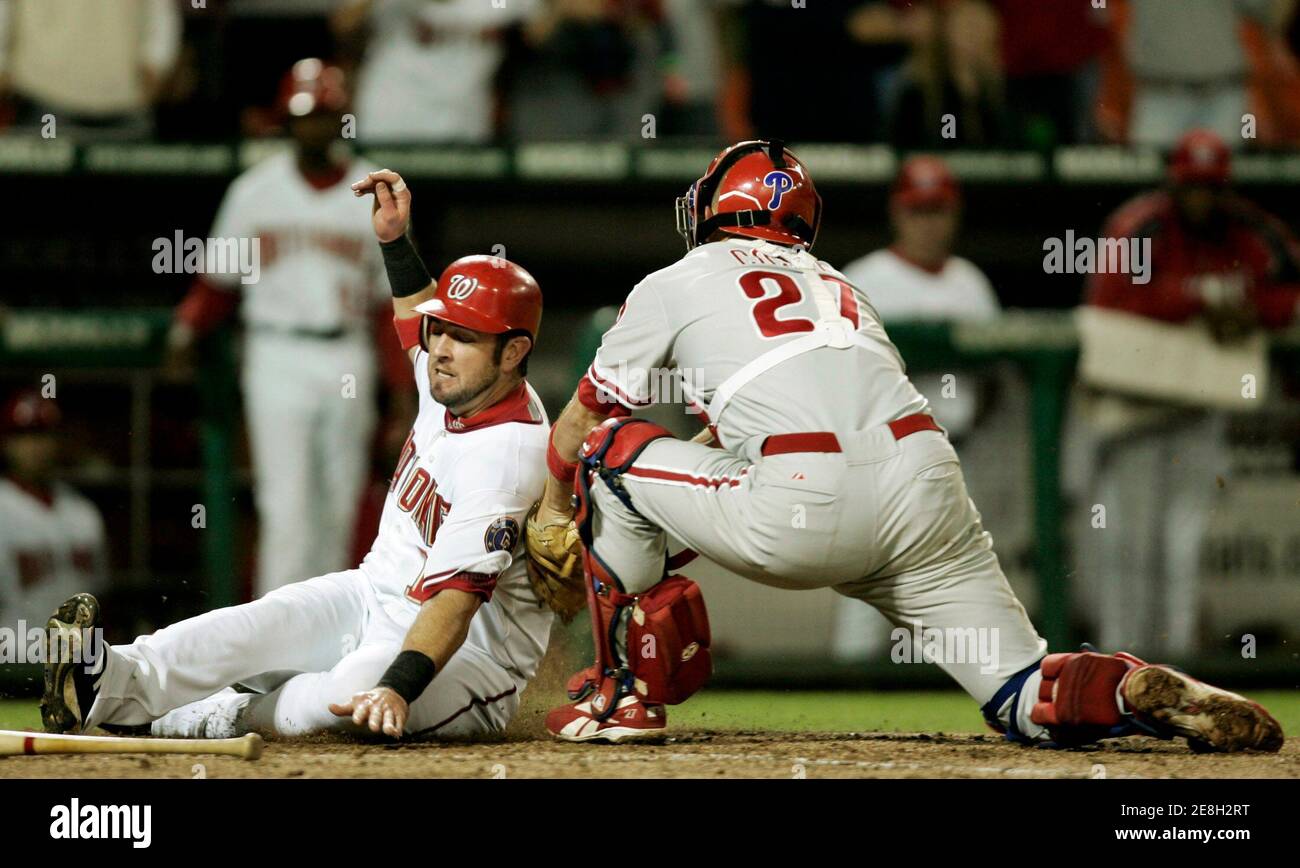 Washington Nationals baserunner Ryan Church (L) is tagged out at home plate in the fifth inning by Philadelphia Phillies catcher Chris Coste during their National League baseball game in Washington September 29, 2006. REUTERS/Gary Cameron (UNITED STATES) Stock Photo