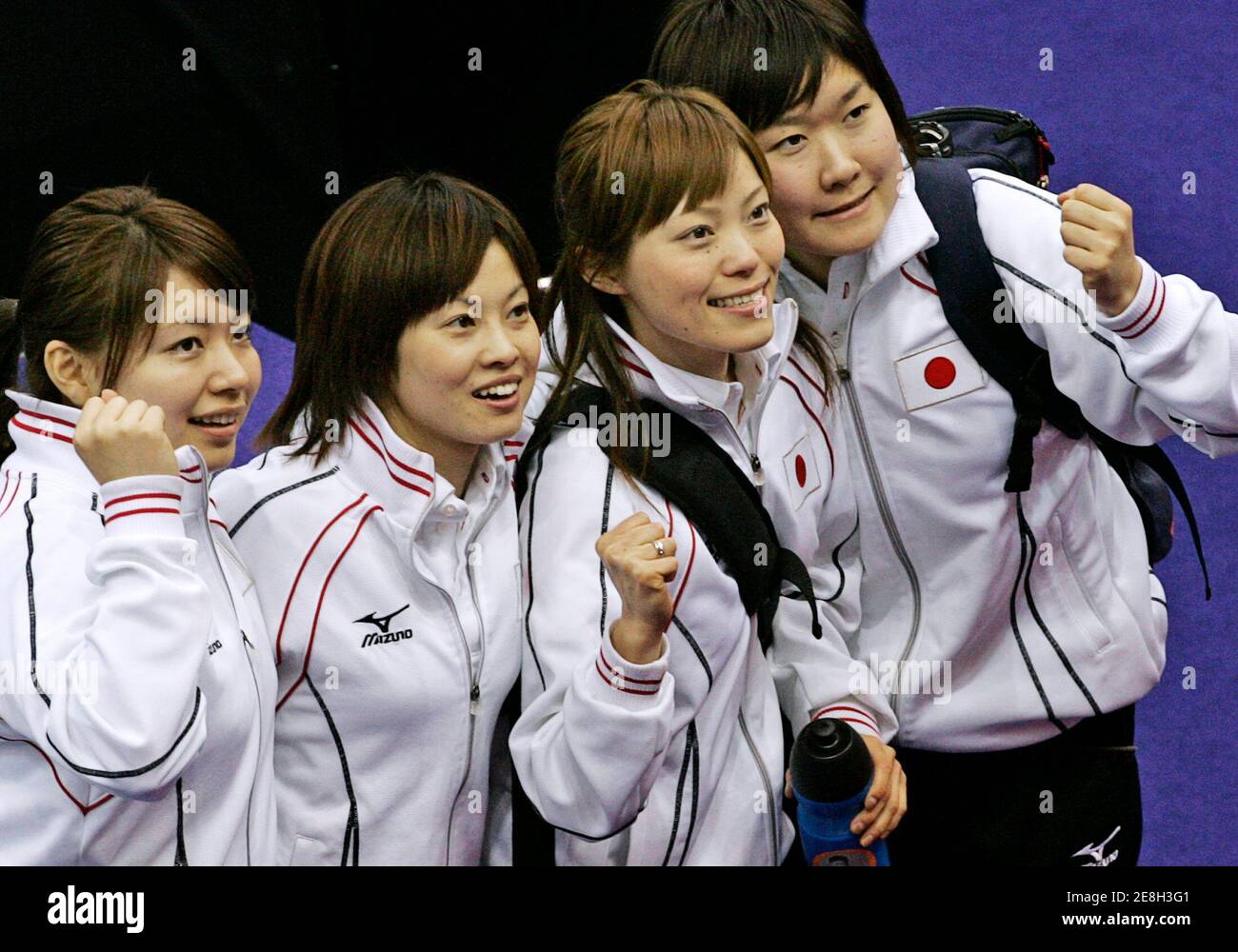Japan's women's curling team (L-R) Mari Motohashi, second, Yumie Hayashi, third, Ayumi Onocdera, Skip and lead Moe Meguropose pose after defeating Italy during the Torino 2006 Winter Olympic Games in Pinerolo, Italy February 20, 2006. Japan won the match 6-4. REUTERS/Andy Clark Stock Photo