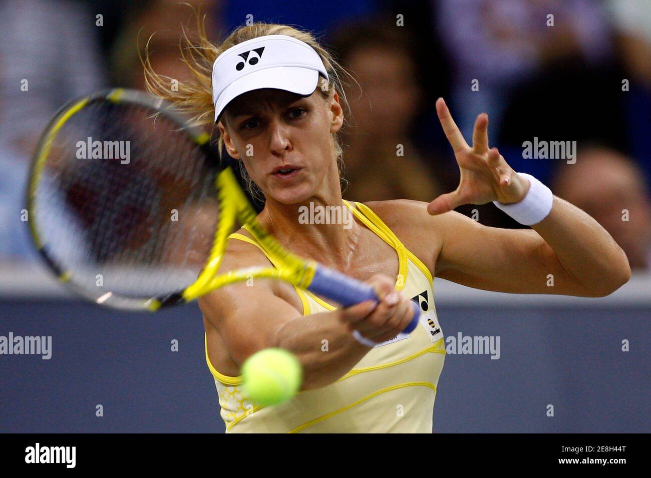 Elena Dementieva of Russia plays a shot to Justine Henin of Belgium ...
