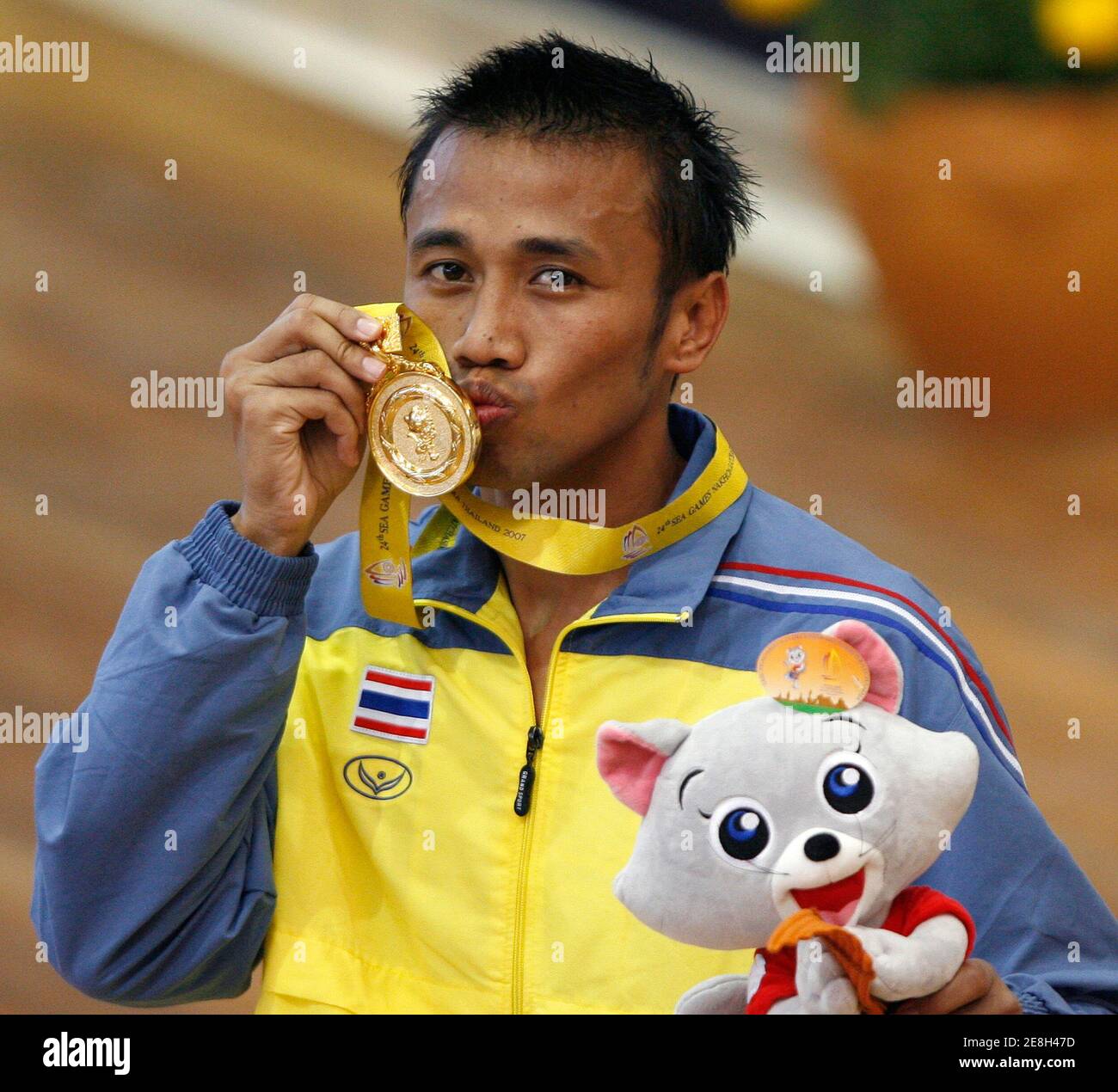 Thailand's Manus Boonjamnong kisses his gold medal after his win over Philippines' Larry Semillano during the Men's Lt. welter weight 64kg boxing final at the SEA Games in Nakhon Ratchasima December 13, 2007.     REUTERS/Chaiwat Subprasom (THAILAND) Stock Photo