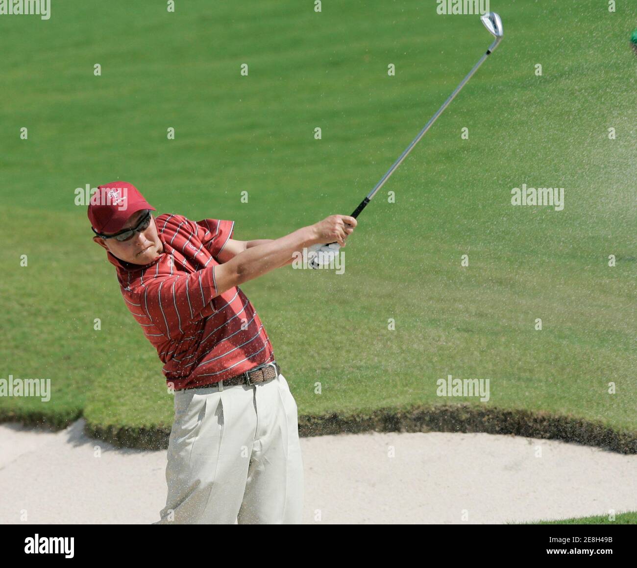 Toru Taniguchi of Japan hits a shot out of the bunker on the 2nd hole during the inaugural Royal Trophy golf Championship at Amata Spring Country Club on the outskirts of Bangkok January 12, 2007.   REUTERS/Chaiwat Subprasom (THAILAND) Stock Photo