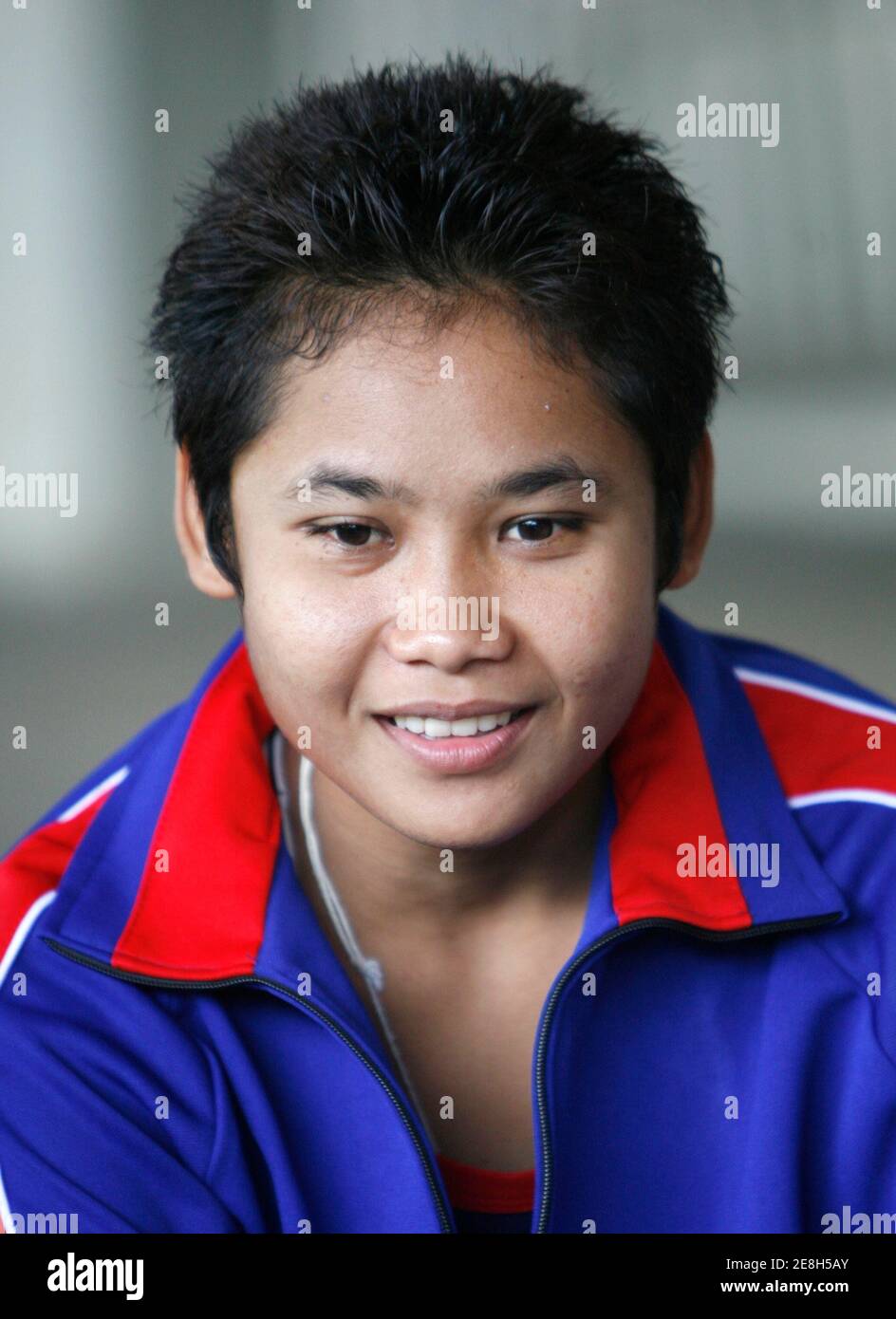 Convicted drugs dealer Samson Sor Siriporn Taweesook, 24, smiles before being released on parole from the Women's Correctional Institution for Drug Addicts in Pathum Thani province, on the outskirts of Bangkok, June 13, 2007. Siriporn was released three years earlier as a reward for winning the World Boxing Council (WBC) female light flyweight title. She was caught selling 'ya ba' (crazy drug) or methamphetamine pills 10 years ago. REUTERS/Chaiwat Subprasom (THAILAND) Stock Photo