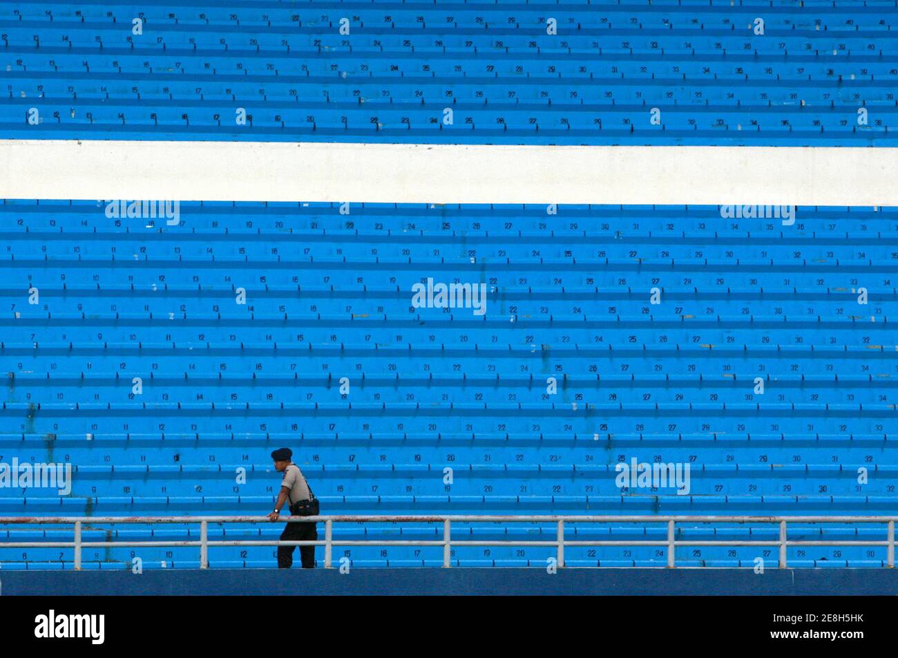 A police officer stands guard during a match between Saudi Arabia and Bahrain at the 2007 AFC Asian Cup Group D soccer match in Palembang July 18, 2007.  REUTERS/Beawiharta   (INDONESIA) Stock Photo