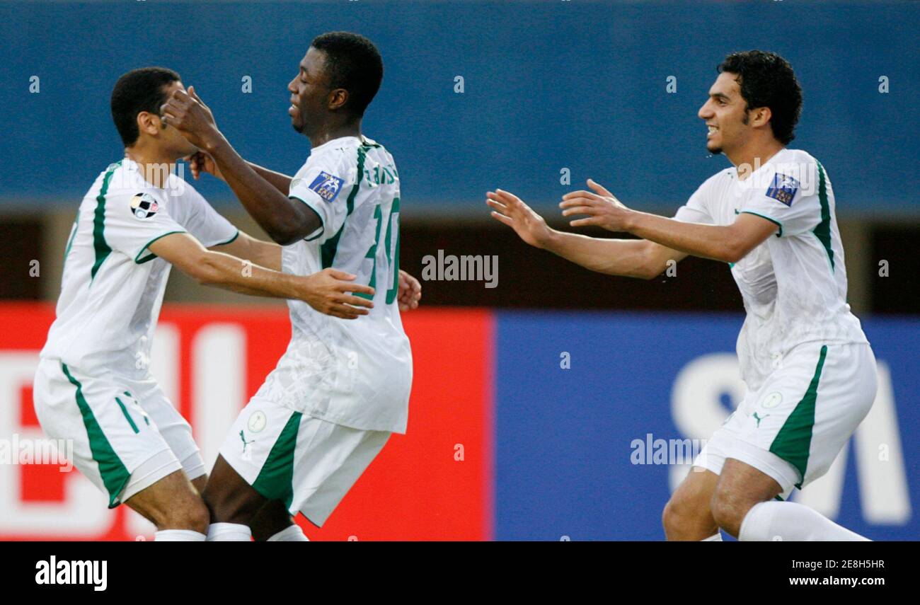 Saudi Arabia's players celebrate after scoring the first goal during their 2007 AFC Asian Cup Group D soccer match against Bahrain's in Indonesia city of Palembang July 18, 2007. REUTERS/Beawiharta (INDONESIA) Stock Photo