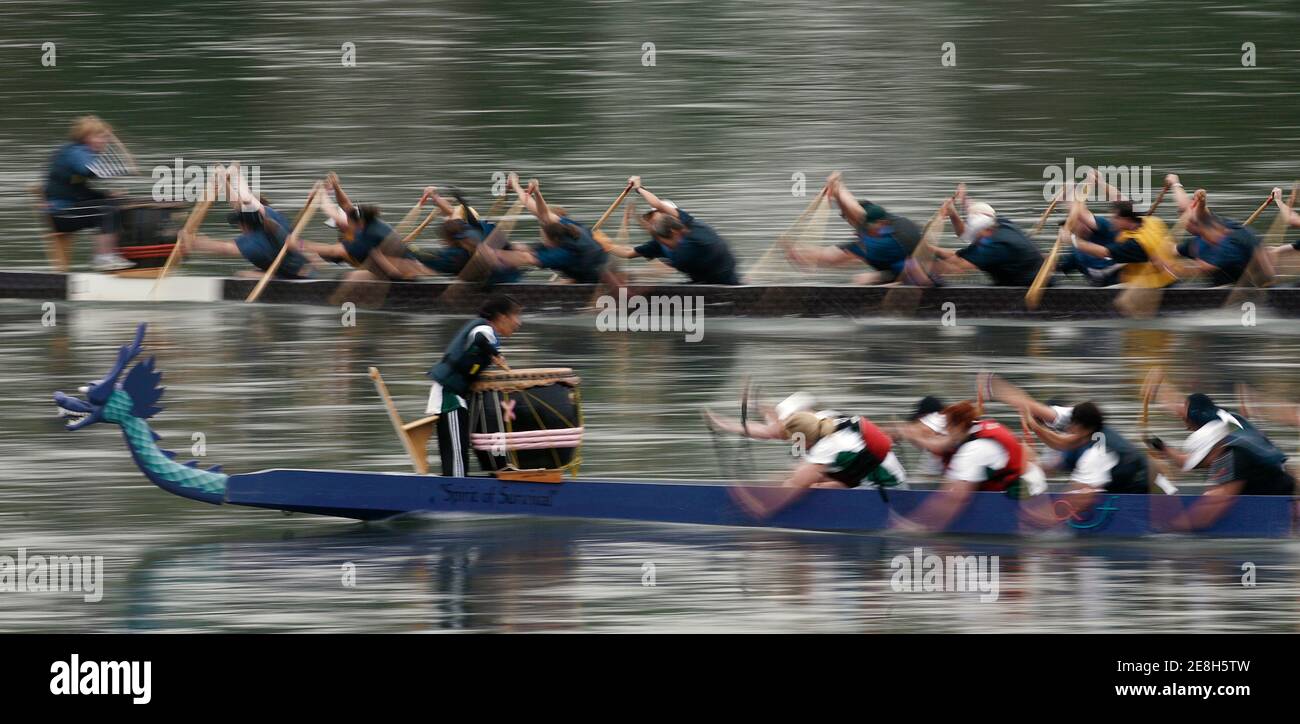Participants in the annual dragon boat races fight the current up the North Saskatchewan River Edmonton, Alberta August 19, 2007.         REUTERS/Andy Clark     (CANADA) Stock Photo