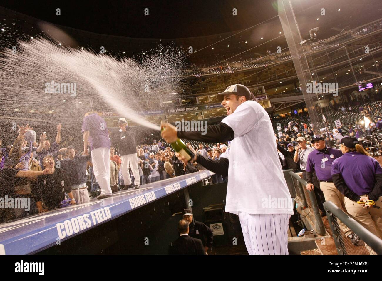 Colorado Rockies player Matt Herges sprays fans with champagne after their win over the San Diego Padres in the 13 innings of their MLB National League Wild Card tiebreaker baseball game in Denver, Colorado, October 1, 2007. The Rockies won the game 9-8 and now advance to the National League Division Series against the Philadelphia Phillies.     REUTERS/Rick Wilking (UNITED STATES - Tags: SPORT BASEBALL) BEST QUALITY AVAILABLE Stock Photo