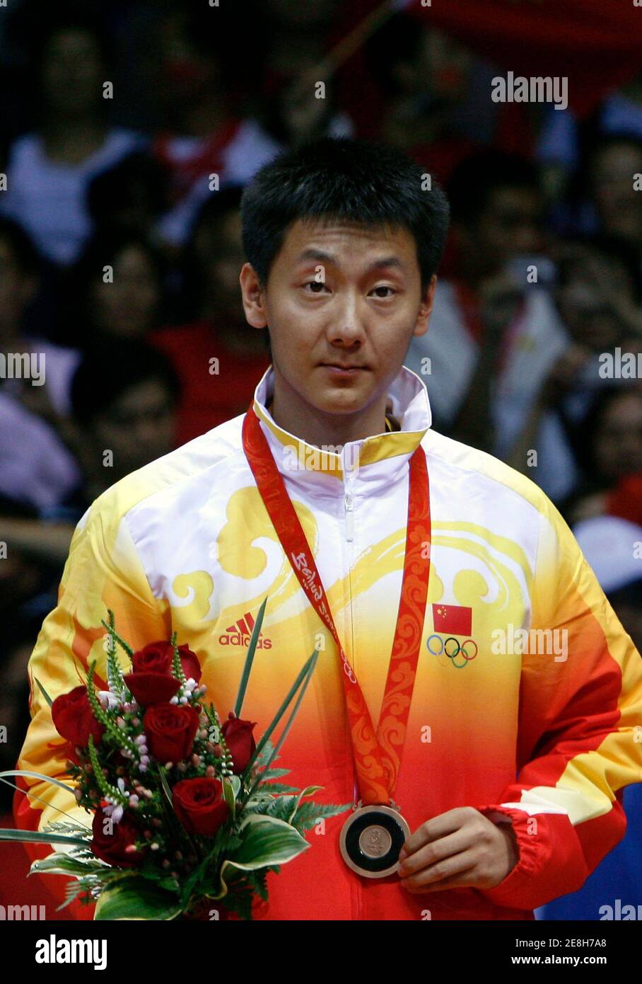 Chen Jin of China celebrates with his bronze medal during the medal ceremony for the men's badminton singles at the Beijing 2008 Olympic Games August 17, 2008.     REUTERS/Beawiharta (CHINA) Stock Photo
