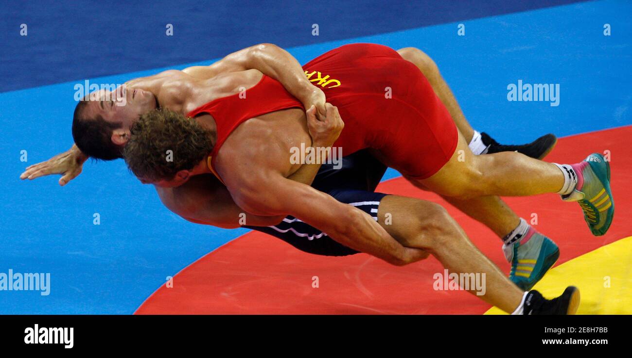Taras Danko of Ukraine (in red) fights Serhat Balci of Turkey during their 84kg men's freestyle wrestling bronze medal match at the Beijing 2008 Olympic Games August 21, 2008.     REUTERS/Oleg Popov (CHINA) Stock Photo