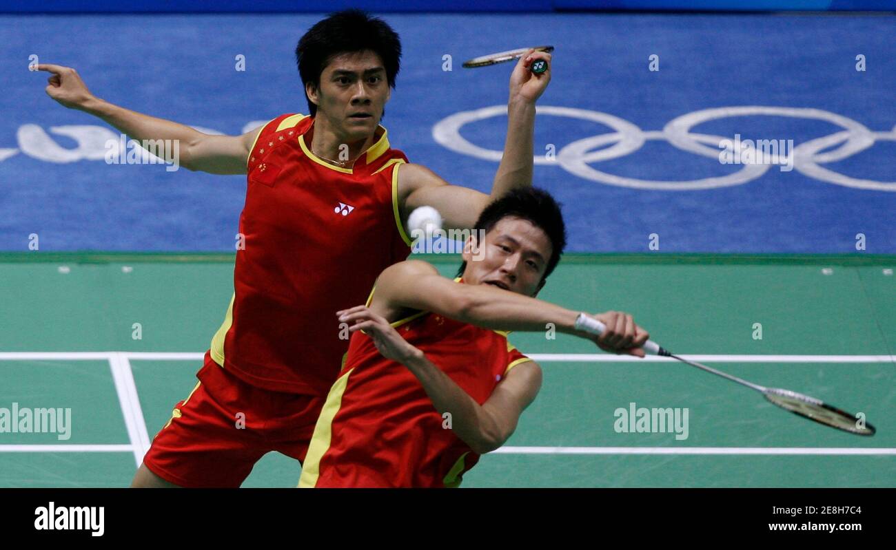 Cai Yun (front) of China plays a shot as his teammate Fu Haifeng watches during their men's doubles round of 16 badminton match against Jens Dyrloev Eriksen and Martin Lundgaard Hansen of Denmark at the Beijing 2008 Olympic Games, August 12, 2008.     REUTERS/Beawiharta (CHINA) Stock Photo