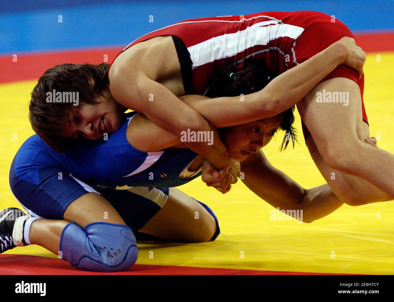 Tatyana Bakatyuk of Kazakhstan  (in red) fights Carol Huynh of Canada during their 48kg  women's semi-final freestyle wrestling match at the Beijing 2008 Olympic Games August 16, 2008.     REUTERS/Oleg Popov (CHINA) Stock Photo