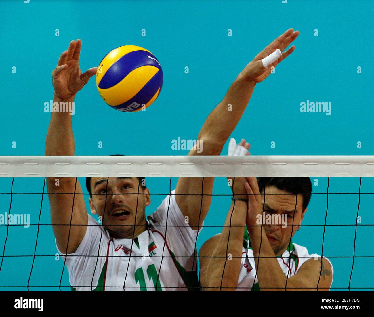 Vladimir Nikolov (L) and Evgeni Ivanov of Bulgaria attempt a block during their men's preliminary Pool A volleyball match against Venezuela at the Beijing 2008 Olympic Games August 18, 2008.     REUTERS/Oleg Popov (CHINA) Stock Photo