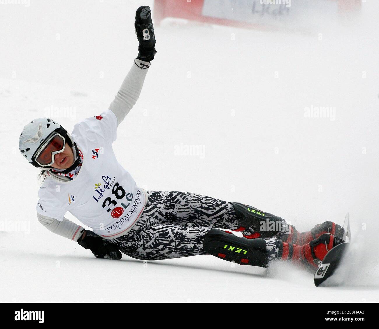 Nina Micic of Serbia falls during the women's snowboard parallel slalom  qualification at the FIS Snowboard World Championships in Hoengseong, east  of Seoul, January 21, 2009. REUTERS/Jo Yong-Hak (SOUTH KOREA Stock Photo -