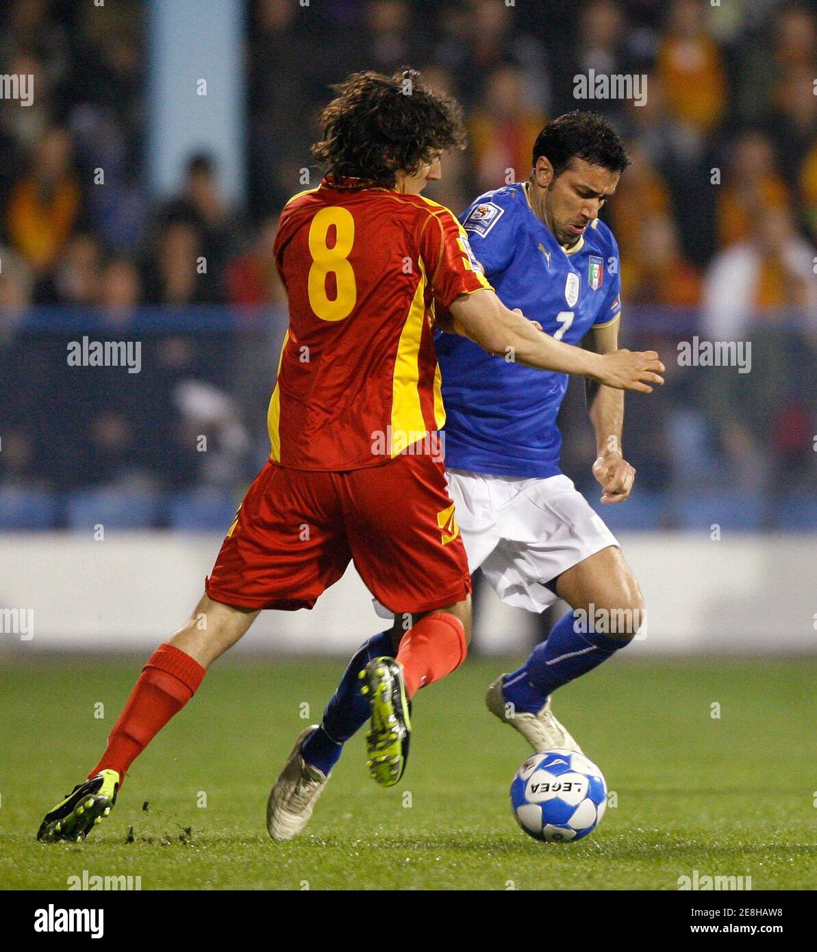 Italy's Fabio Quagliarella (R) is challenged by Montenegro's Stevan Jovetic during their 2010 World Cup qualifying soccer match in Podgorica March 28, 2009.  REUTERS/Ivan Milutinovic (MONTENEGRO SPORT SOCCER) Stock Photo