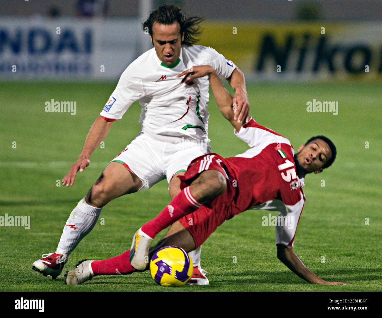 Amir Mubarak (R) of the United Arab Emirates fights for the ball with Iran's Ali Karimi during their 2010 Fifa World Cup qualifying soccer match at Tehran's Azadi stadium June 10, 2009. REUTERS/Raheb Homavandi (IRAN SPORT SOCCER) Stock Photo