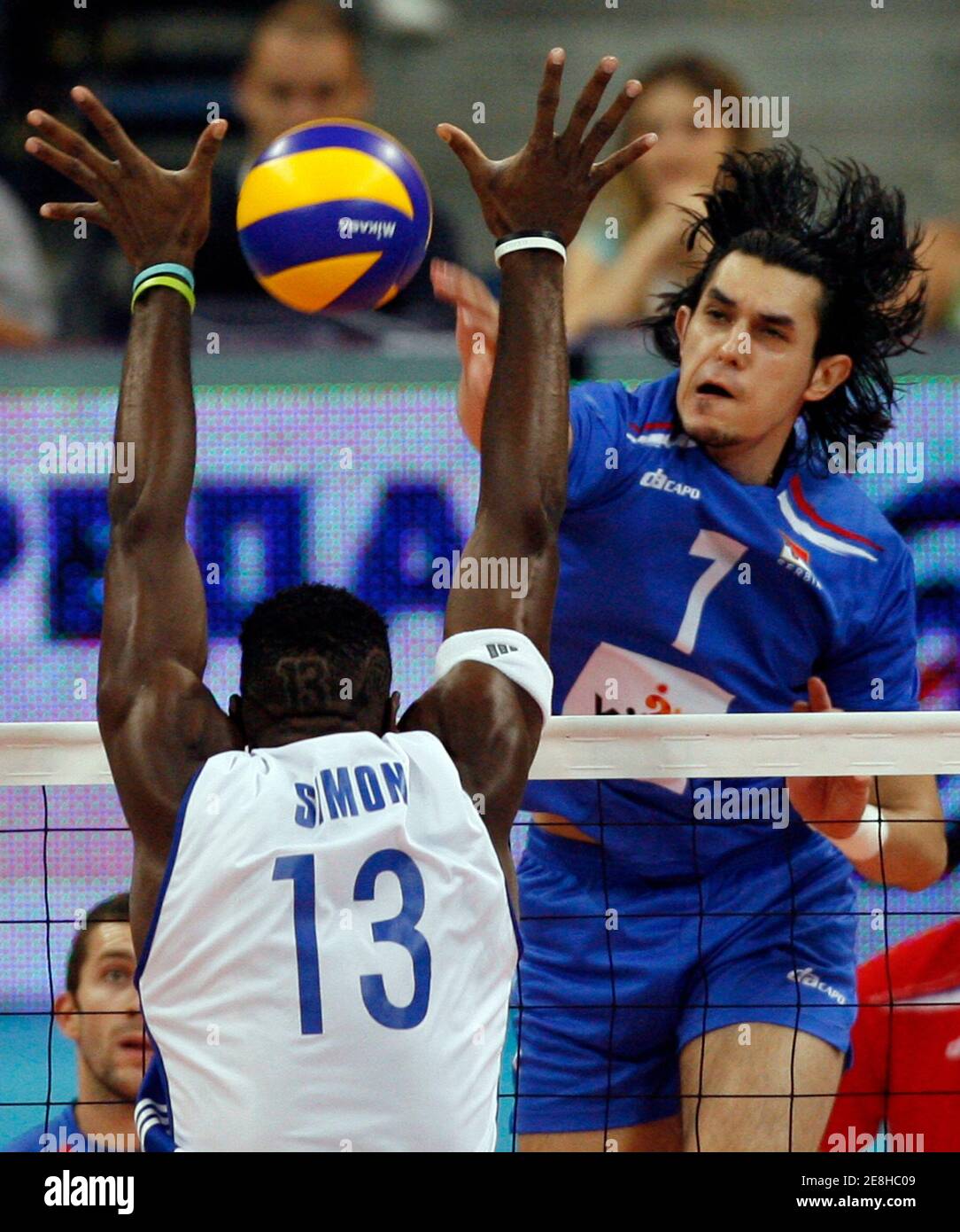 Serbia's Dragan Stankovic (R) spikes the ball against Cuba's Aties Roberlandy Simon during their men's World League 2009 final round volleyball match in Belgrade July 25, 2009.  REUTERS/Ivan Milutinovic (SERBIA SPORT VOLLEYBALL) Stock Photo