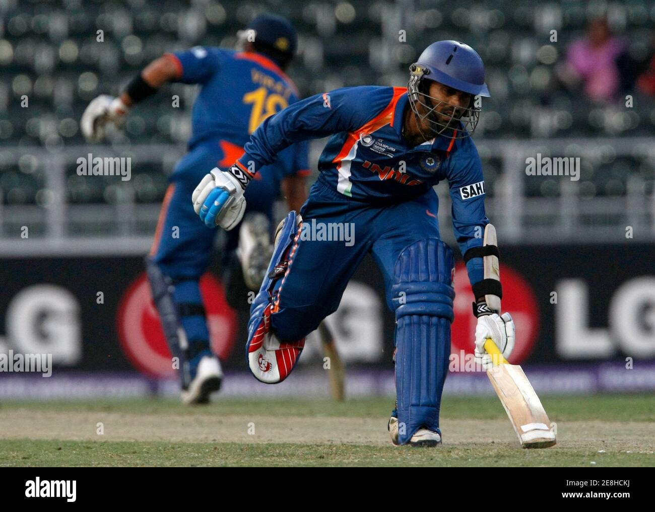 India's Dinesh Karthik runs between the wickets during their ICC Champions Trophy cricket match against the West Indies in Johannesburg, September 30, 2009. REUTERS/Mike Hutchings (SOUTH AFRICA SPORT CRICKET) Stock Photo