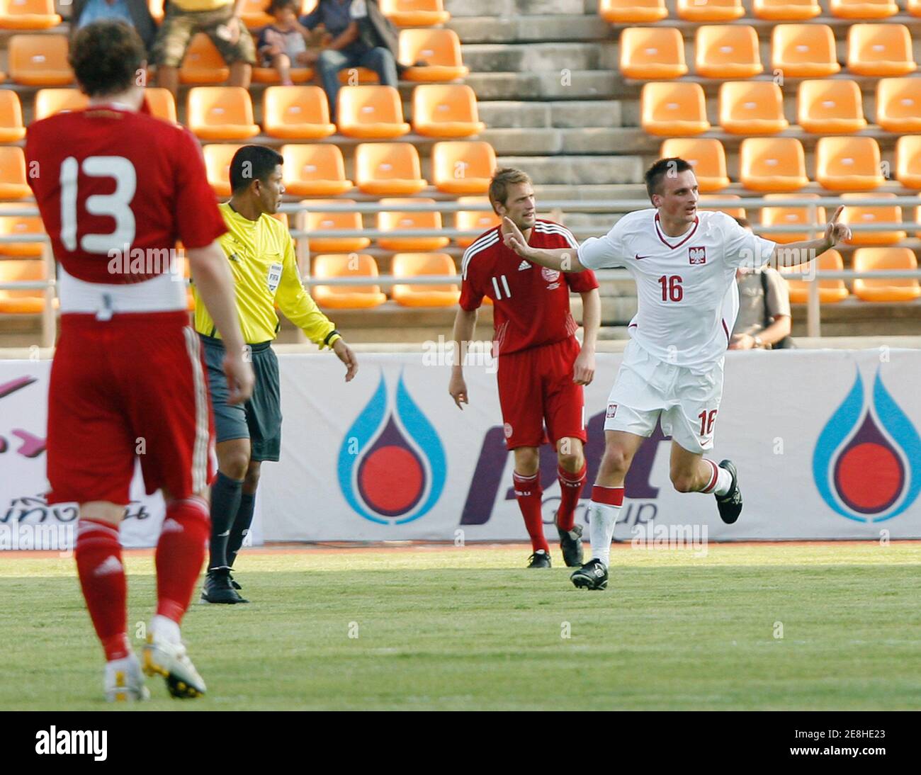 Poland's Slawomir Peszko (R) celebrates after scoring during their Thailand King's Cup football tournament against Denmark at His Majesty The 80th Birthday Anniversary stadium in Nakhon Ratchasima province northeast of Bangkok, January 17, 2010. REUTERS/Chaiwat Subprasom  (THAILAND - Tags: SPORT SOCCER) Stock Photo