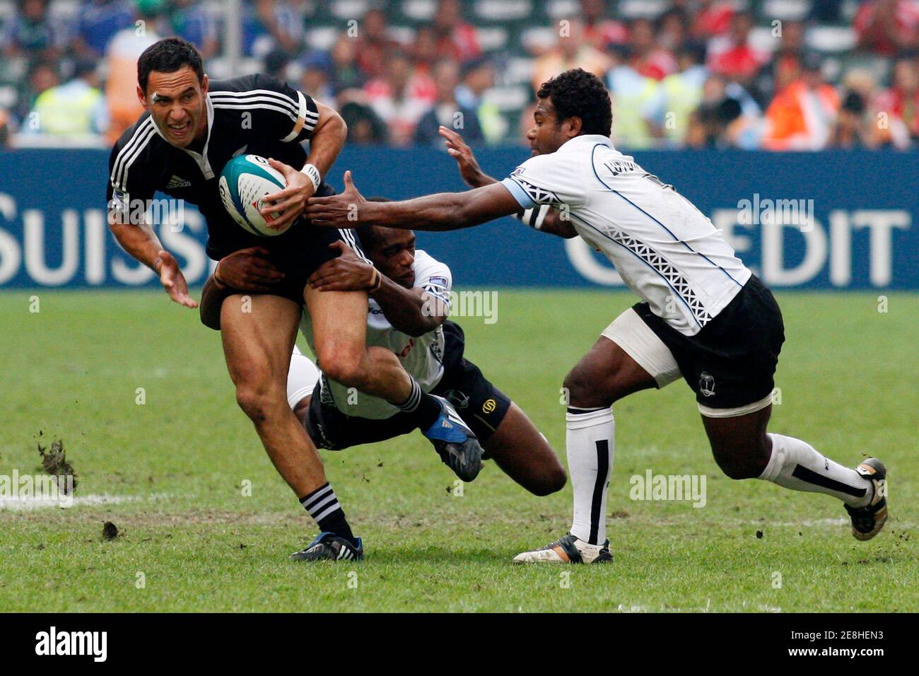 New Zealand's Zar Lawrence (L) is tackled by Fuji's Jiuta Lutumailagi (R) and Watisoni Votu during the Cup semi finals of the Hong Kong Sevens rugby tournament March 28, 2010. REUTERS/Tyrone Siu  (CHINA - Tags: SPORT RUGBY) Stock Photo