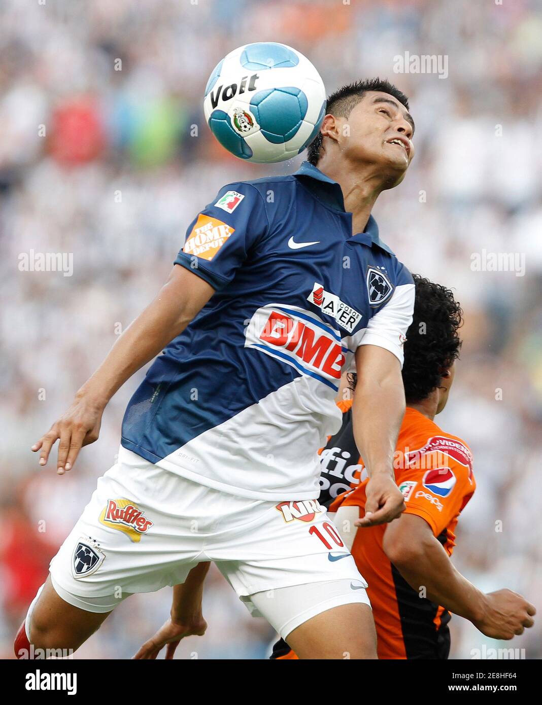 Monterrey's Osvaldo Martinez (L) battles for the ball with Pachuca's Edy Brambila during their Mexican league quarterfinal soccer match at the Tecnologico stadium in Monterrey May 8, 2010. REUTERS/Tomas Bravo (MEXICO - Tags: SPORT SOCCER) Stock Photo