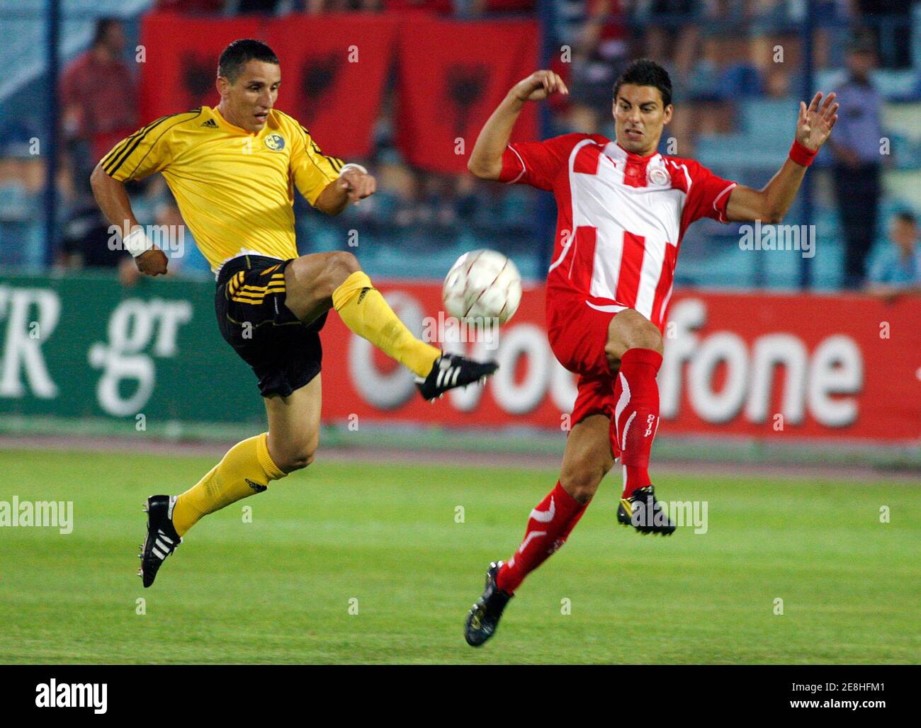 Betim Aliju of KS Besa Kavaje (L) fights for the ball with Savier Discas  Gonzales of Olympiacos FC during the first leg of their UEFA Europa League  second qualifying round soccer match
