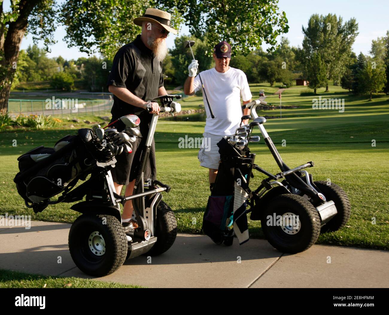 Marvin Hutchens (L) and Jimmy Ray Henson use Segway personal transports at Indian Tree golf course in Arvada, Colorado July 17, 2010.  The Segways for golfers featuring a golf bag rack, scorecard holder, turf-friendly tires were recently introduced at the course.  REUTERS/Rick Wilking (UNITED STATES - Tags: SPORT SOCIETY GOLF) Stock Photo