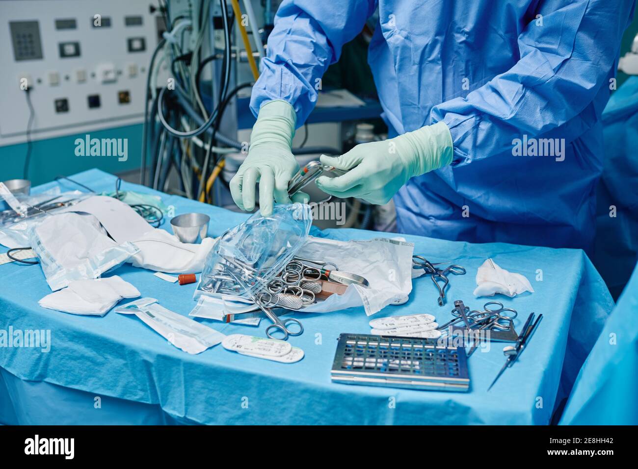 Crop anonymous surgeon in gown and latex gloves choosing various