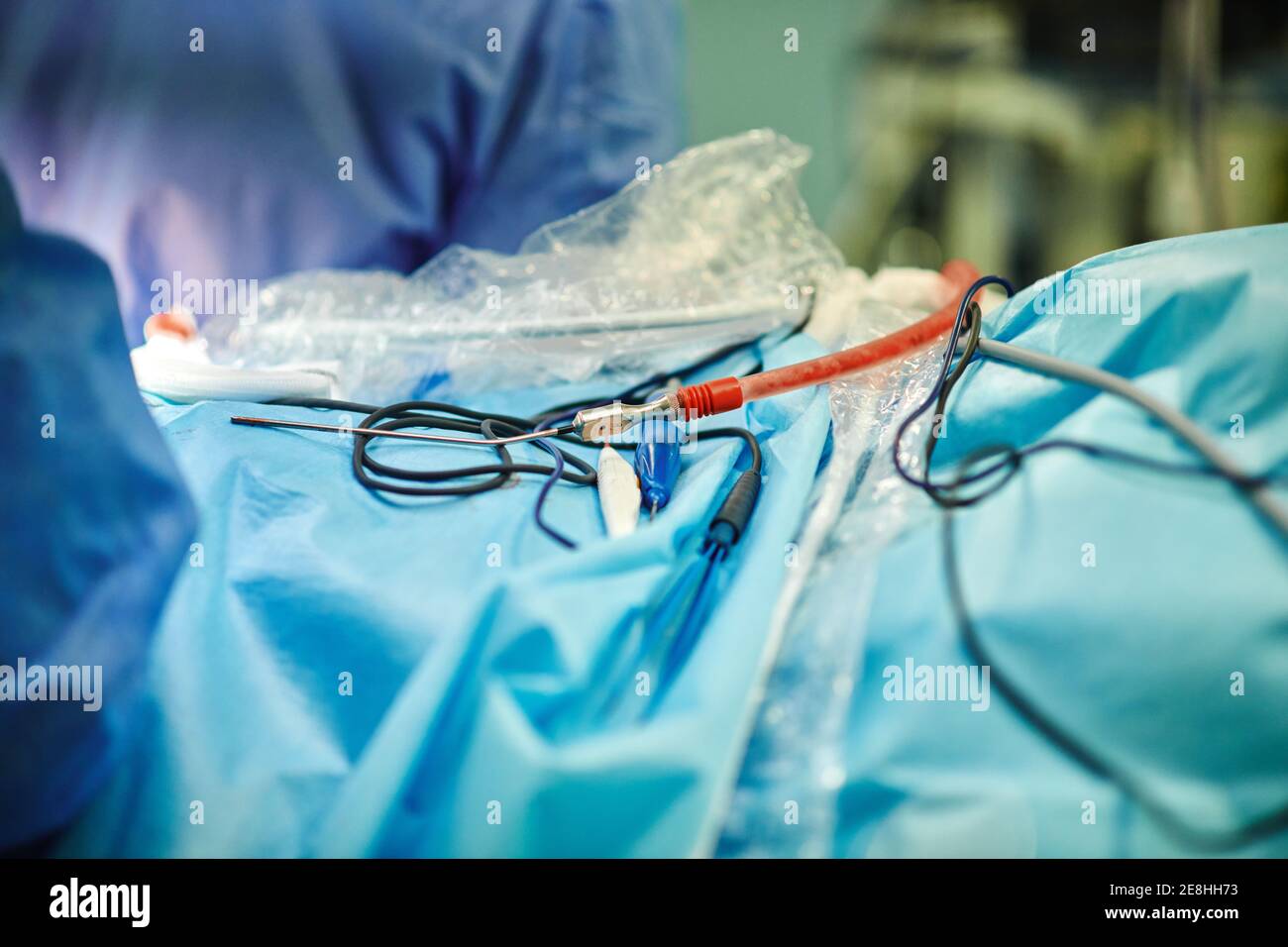 Crop unrecognizable doctors standing near operating table with blood