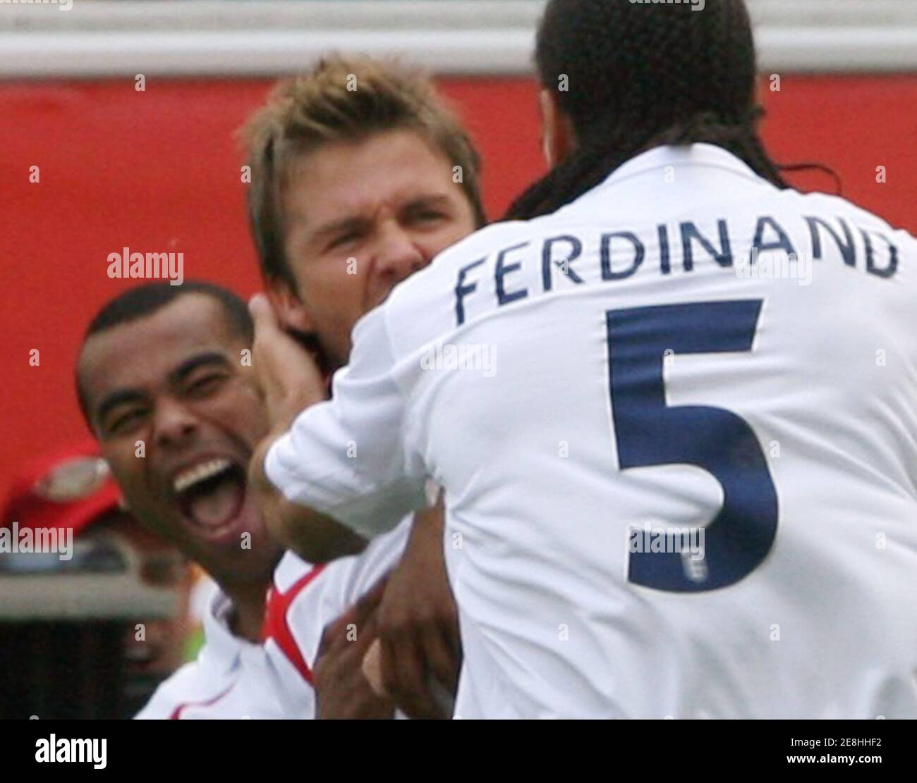 England's Rio Ferdinand (5) celebrates with team mates David Beckham (C) and Ashley Cole during their Group B World Cup 2006 soccer match against Paraguay in Frankfurt June 10, 2006.  FIFA RESTRICTION - NO MOBILE USE    (GERMANY)     REUTERS/Oleg Popov Stock Photo