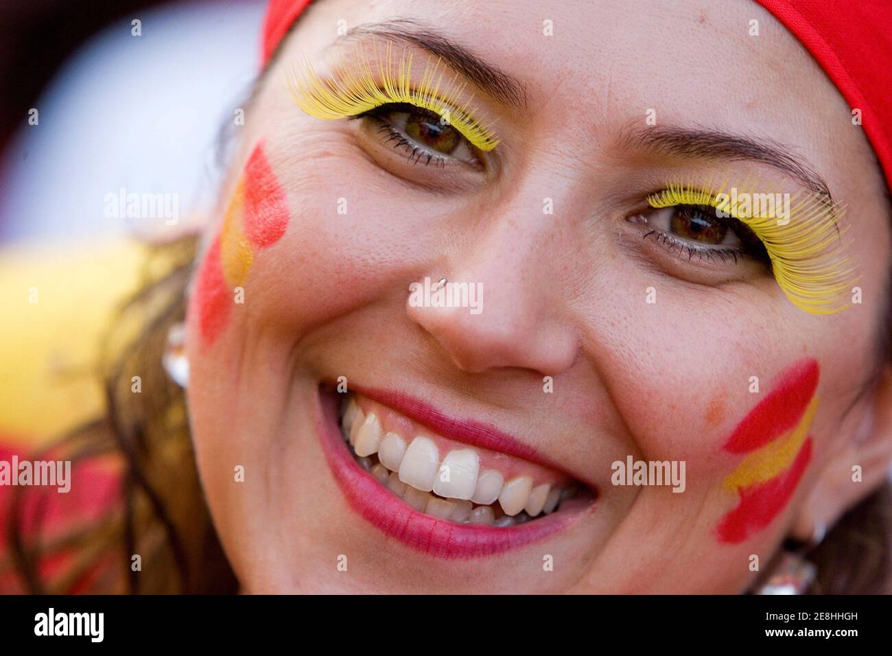 A Spain soccer fan smiles during the second round World Cup 2006 soccer match between Spain and France at a fan festival in Frankfurt June 27, 2006. REUTERS/Miro Kuzmanovic (GERMANY) Stock Photo