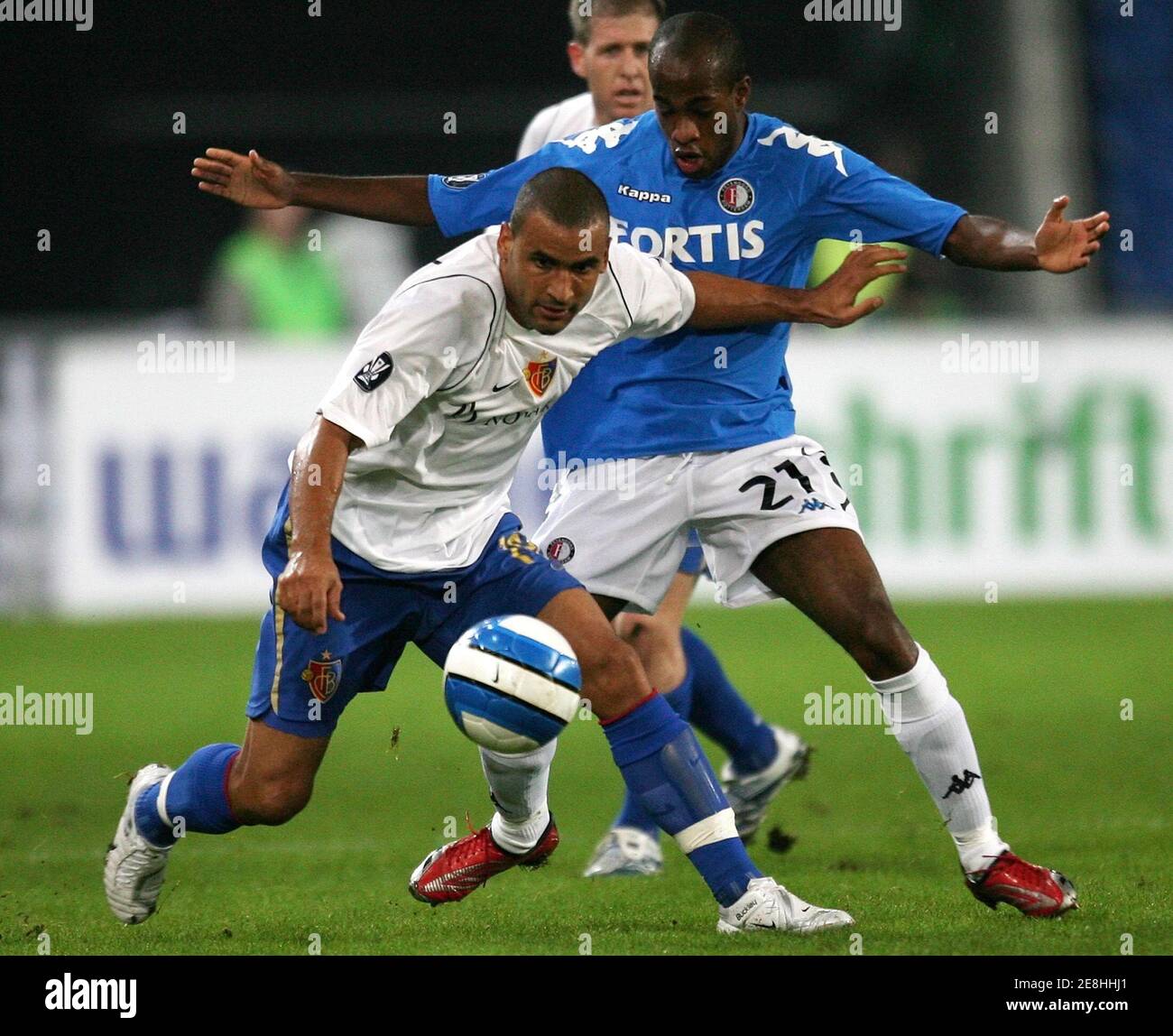 Basel's Delron Buckley (front) challenges Feyenoord Rotterdam's Dwight Tiendalli during their UEFA Cup Group E soccer match in Basel October 19, 2006. REUTERS/Pascal Lauener (SWITZERLAND) Stock Photo