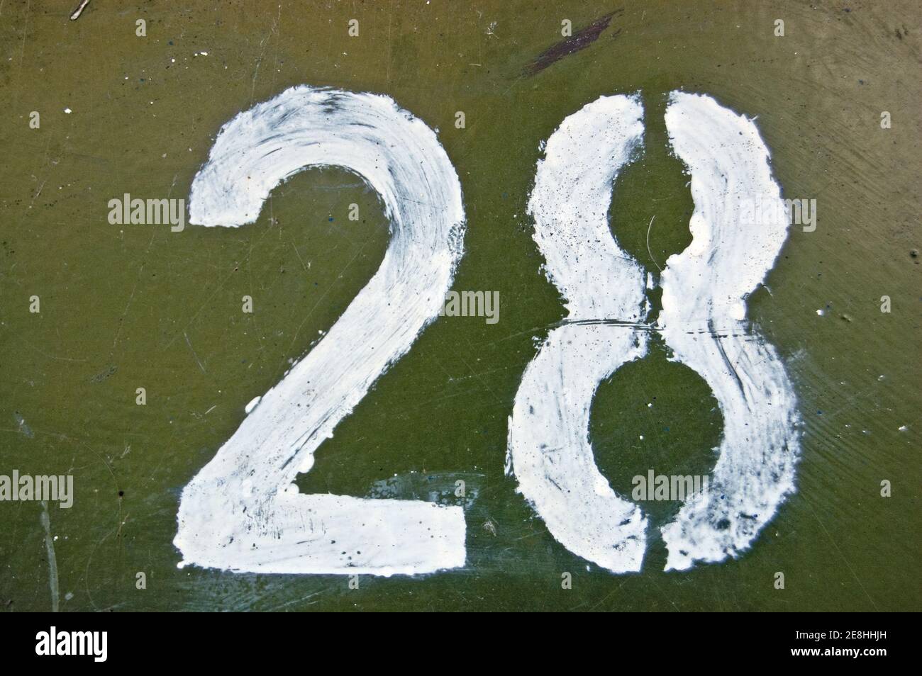 A stencil painting of the number 28. Outer door of a junction box on a public pavement. Stock Photo