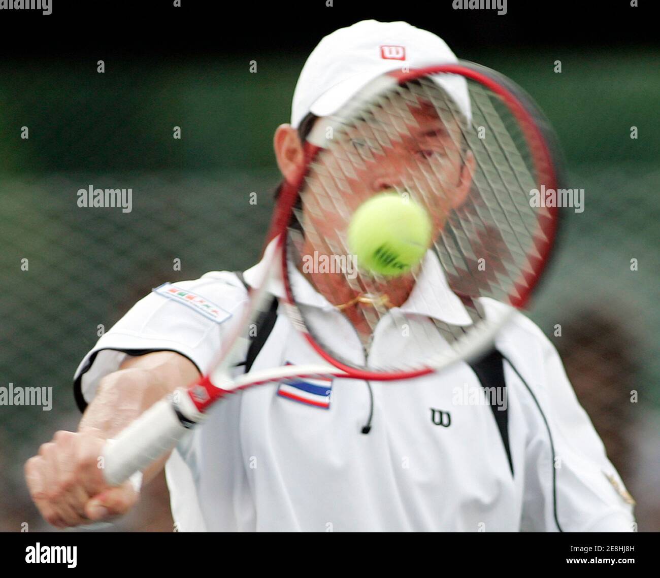 Thailand's Danai Udomchoke hits a shot to Go Soeda of Japan at their Davis Cup Asia/Oceania group One, second round tennis match in Bangkok April 7, 2006. REUTERS/Chaiwat Subprasom Stock Photo