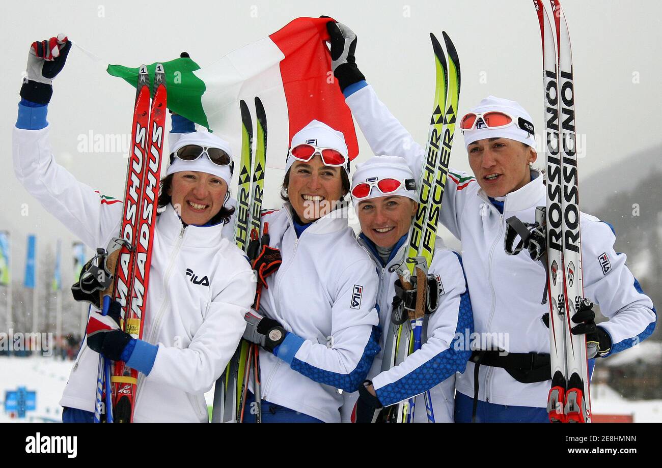 Italy's Sabina Valbusa, Antonella Confortola, Arianna Follis and Gabriella Paruzzi (L-R) celebrate on the podium after placing third in the women's 4x5km cross country team competition at the Torino 2006 Winter Olympic Games in Pragelato, Italy, February 18, 2006. Russia won the race ahead of Germany and Italy. REUTERS/Pascal Lauener Stock Photo